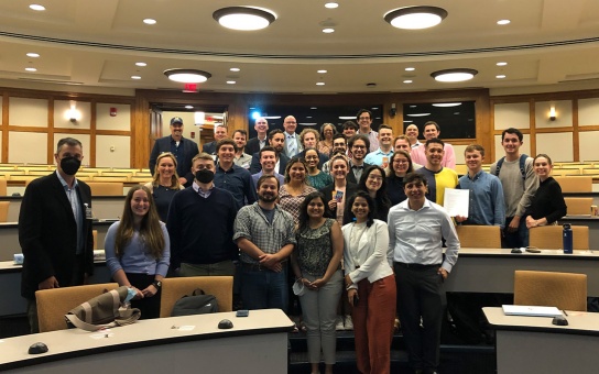 Posed group photo of Ford School student participants, faculty, and US Army War College simulation leader(s) in Annenberg Auditorium